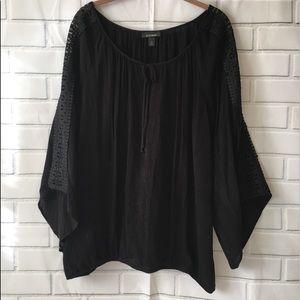 Black long sleeve top with flare out sleeves